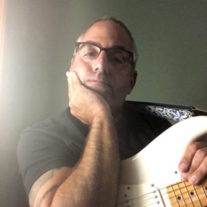 Guitarist Tom Castonzo with white Fender stratocaster