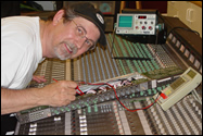 ICM Corp founder Tim Bernovich working on a large studio mixing board